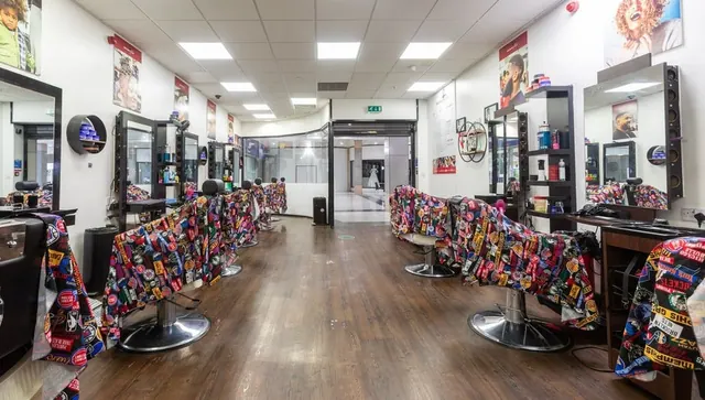 The length of the shop, chairs down both sides