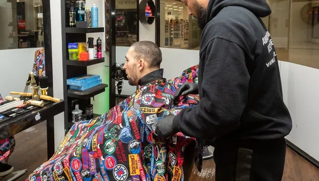A barber at work at a station